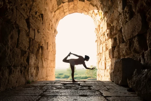 Silhouette of woman doing yoga.