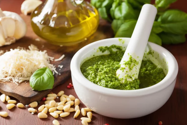 pesto sauce and ingredients over wooden rustic background